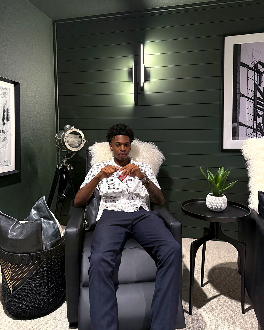 Isaiah Khalil looking into the camera from a leather chair